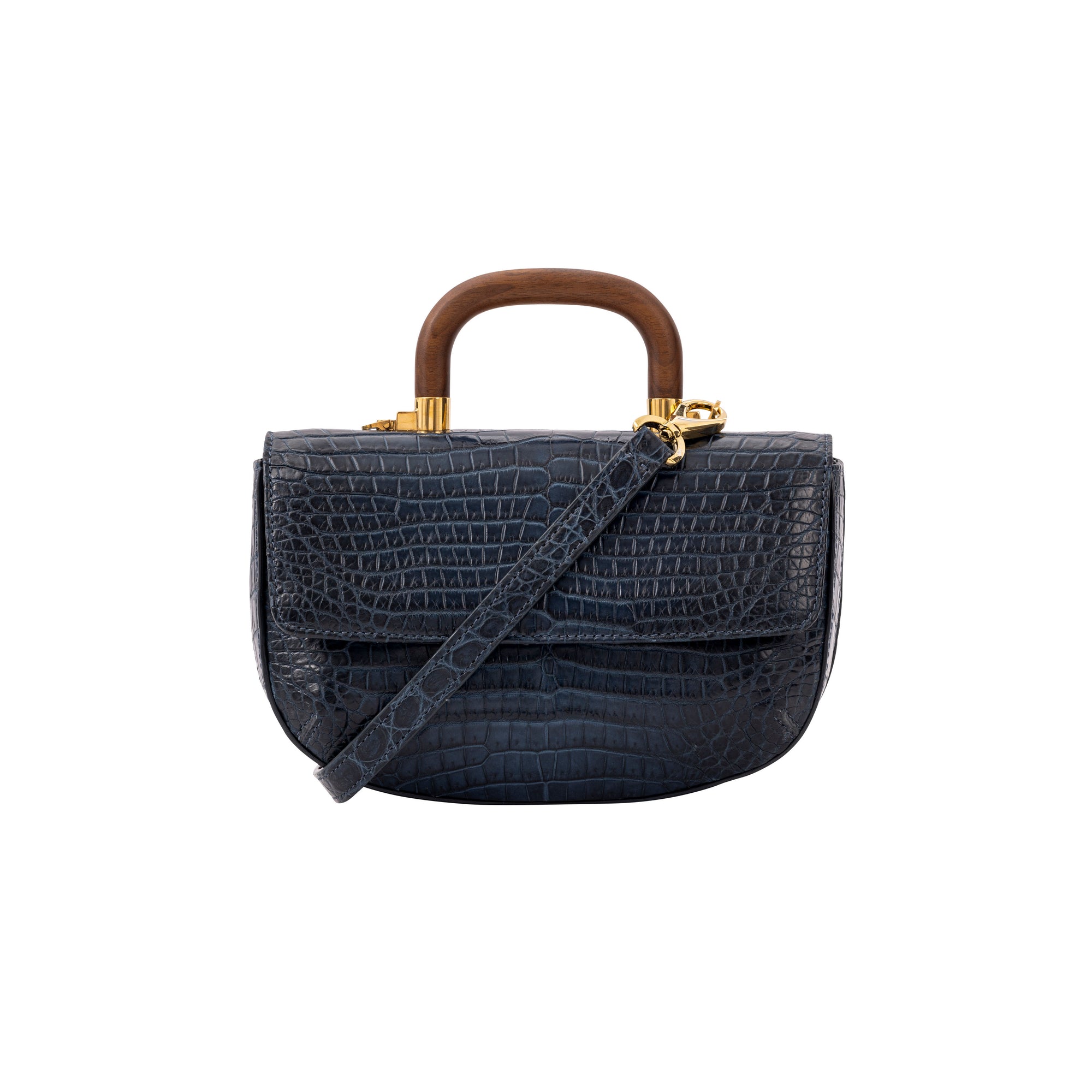 Front of a navy crocodile handbag with a strap and wooden handle on a white background