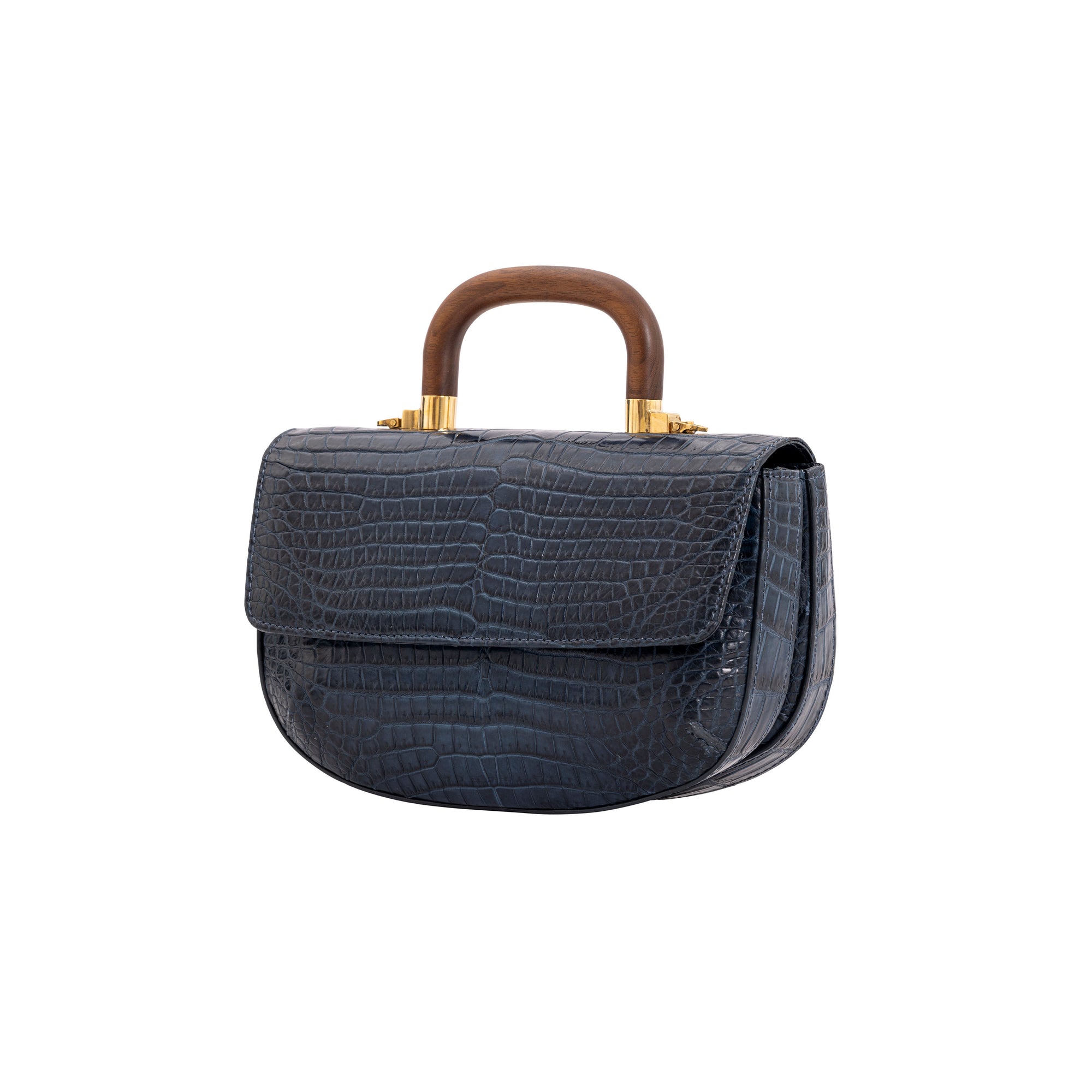 Side of a navy crocodile handbag with a wooden handle on a white background
