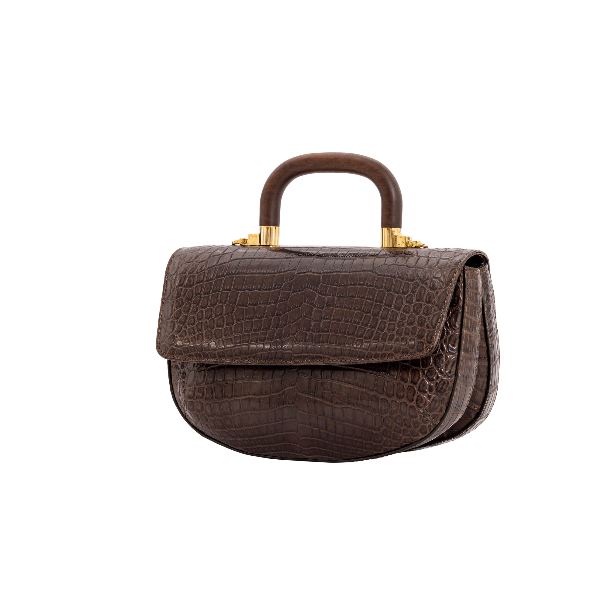 Side of a brown crocodile handbag with a wooden handle on a white background