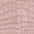 Close-up of a textured pink fabric with a crocodile pattern