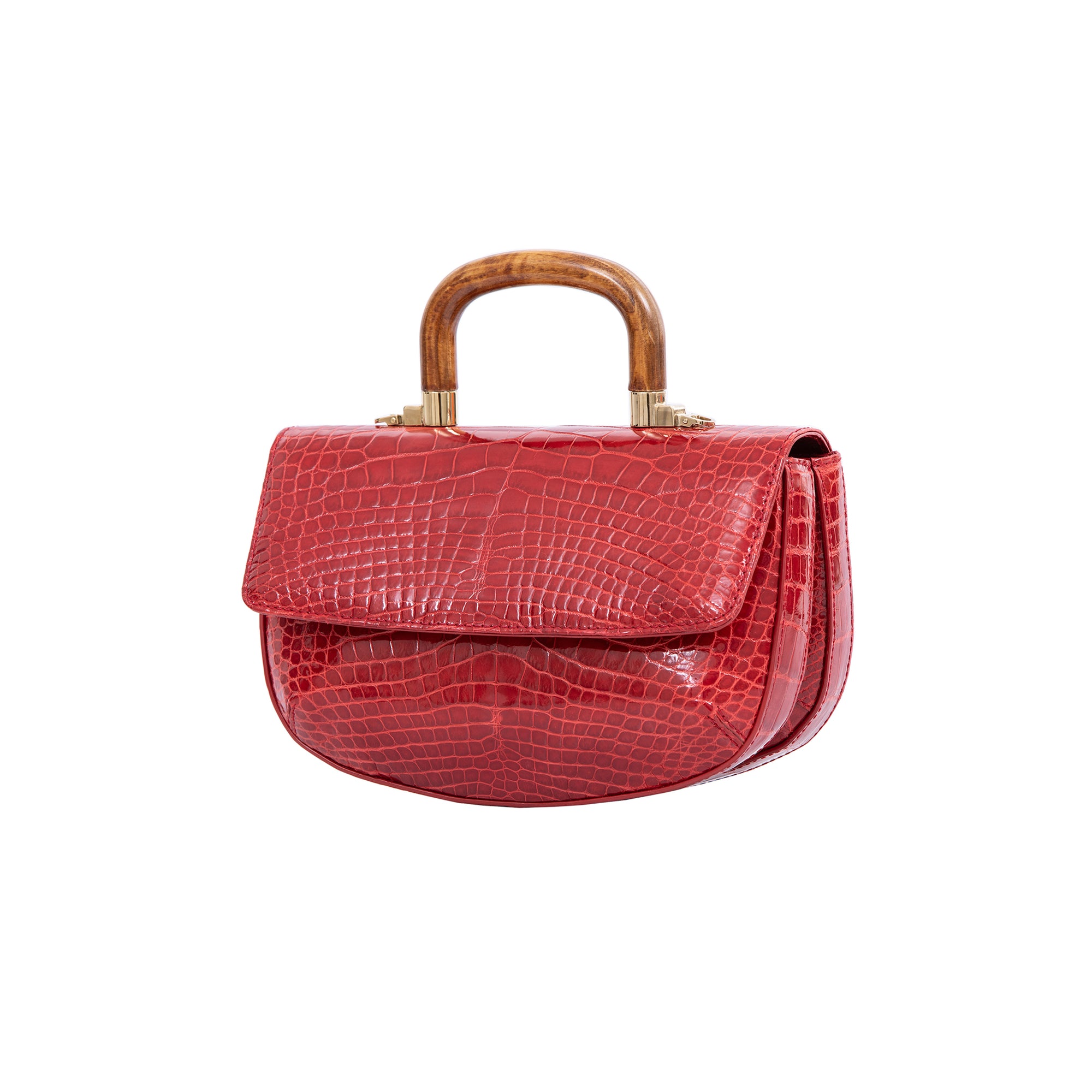 Side of a red crocodile-patterned handbag with a wooden handle on a white background