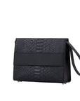 Side of a black python textured handbag on a white background