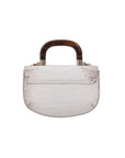 White crocodile-textured handbag with wooden handle on a white background