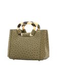 Side of jungle green ostrich handbag with a handle on a white background