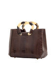 Side of brown handbag with a handle on a white background