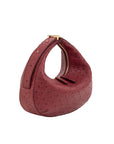 Red ostrich-textured handbag with gold accents on a white background