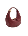 Maroon ostrich-textured handbag with gold zipper on a white background
