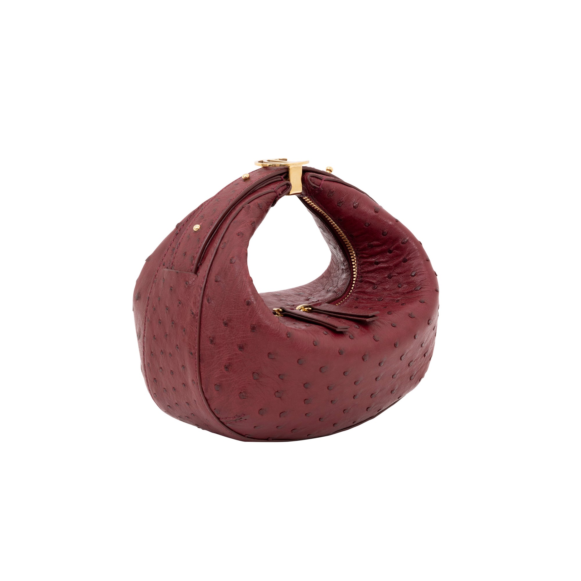 Maroon ostrich-textured handbag with gold zipper on a white background