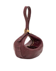 Maroon crocodile-patterned handbag with gold accents on a white background