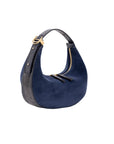 Blue suede handbag with gold accents on a white background