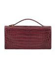 Back of crocodile red textured clutch bag on a white background
