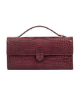 Front of crocodile red textured clutch bag on a white background