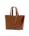 Brown semi suede-textured handbag on a white background