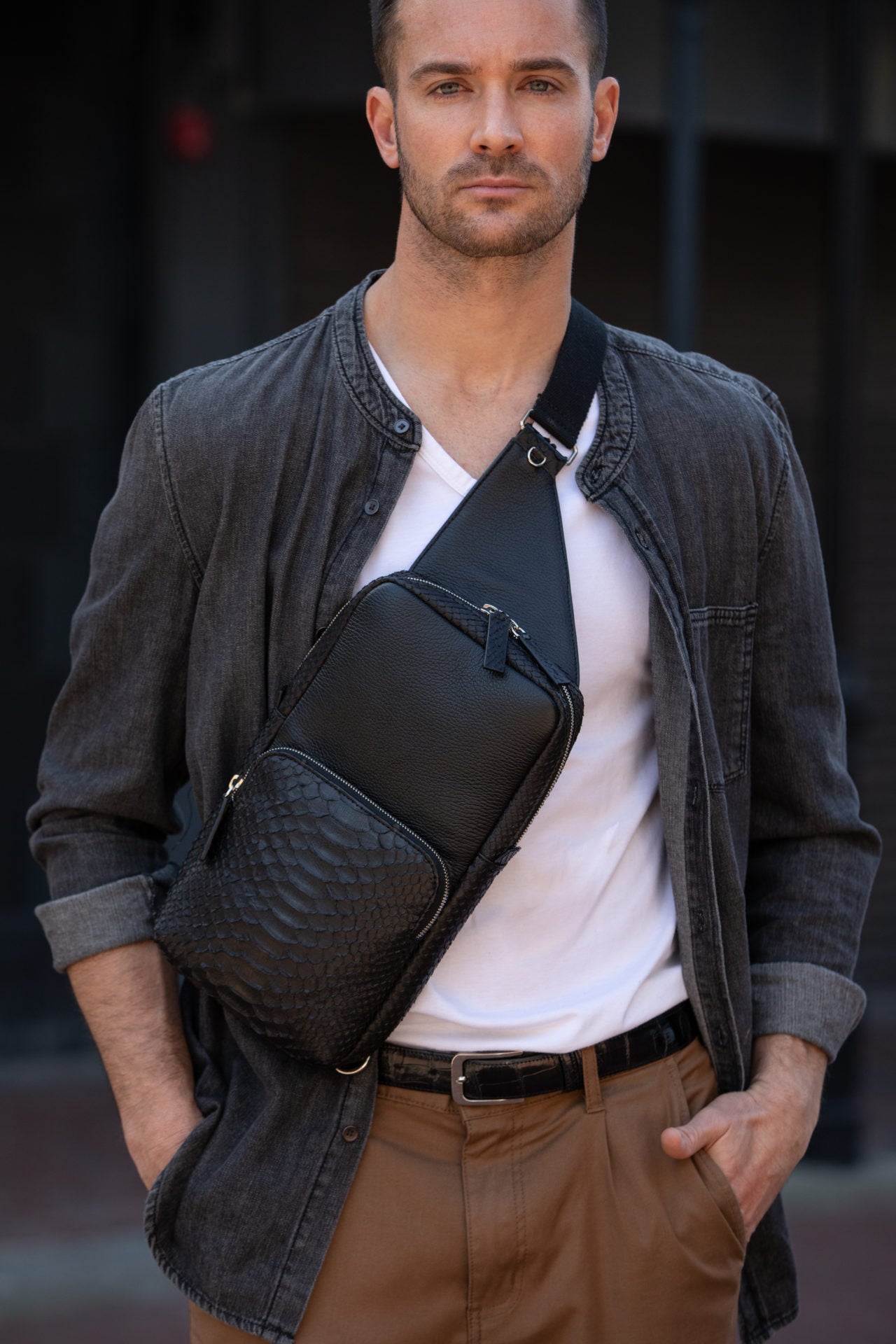 Man wearing a black python textured chest bag