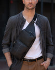 Man wearing a black python textured chest bag