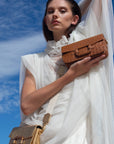 Deya Crossbody in Luggage Ostrich with a wood Ring Detail