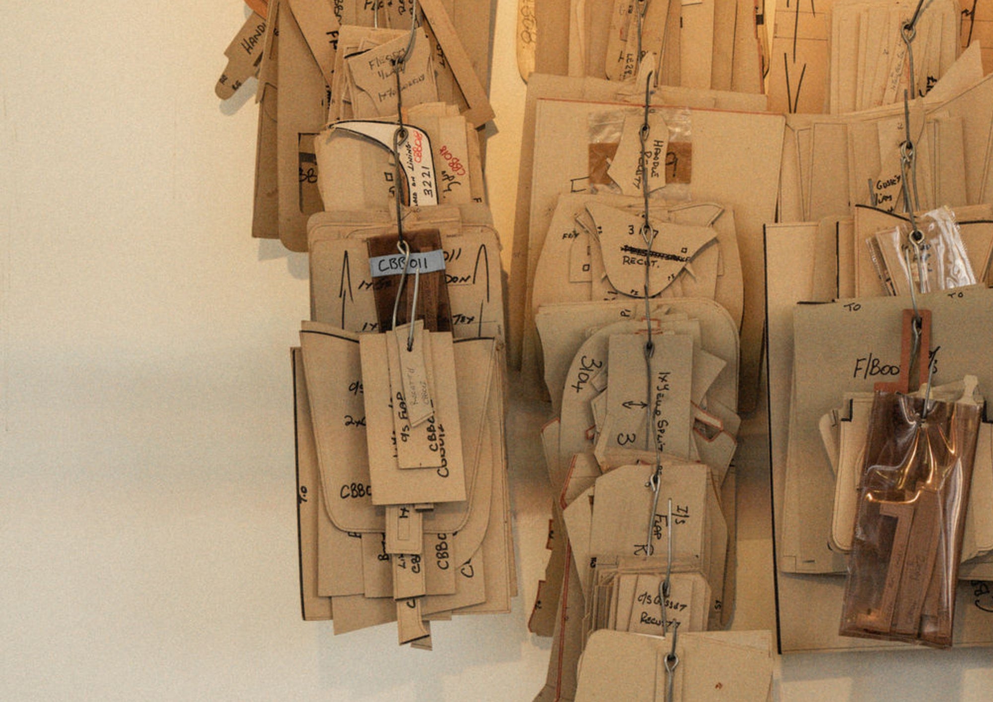 Different wooden shapes with text written on it hanging on a wall