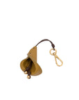 Gold bell with leather strap and keychain on a white background
