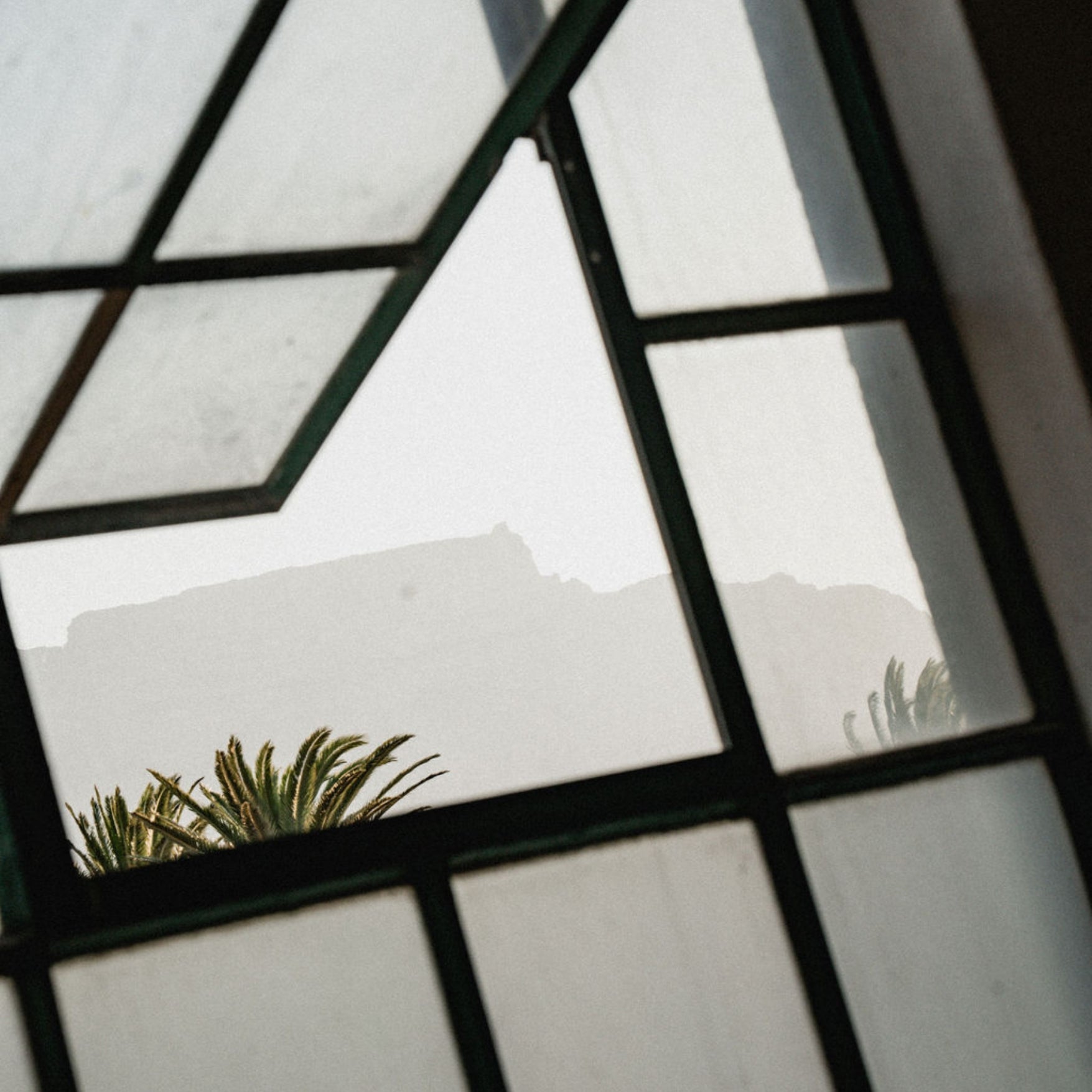 Black framed window design with a view of faded table mountain in the background